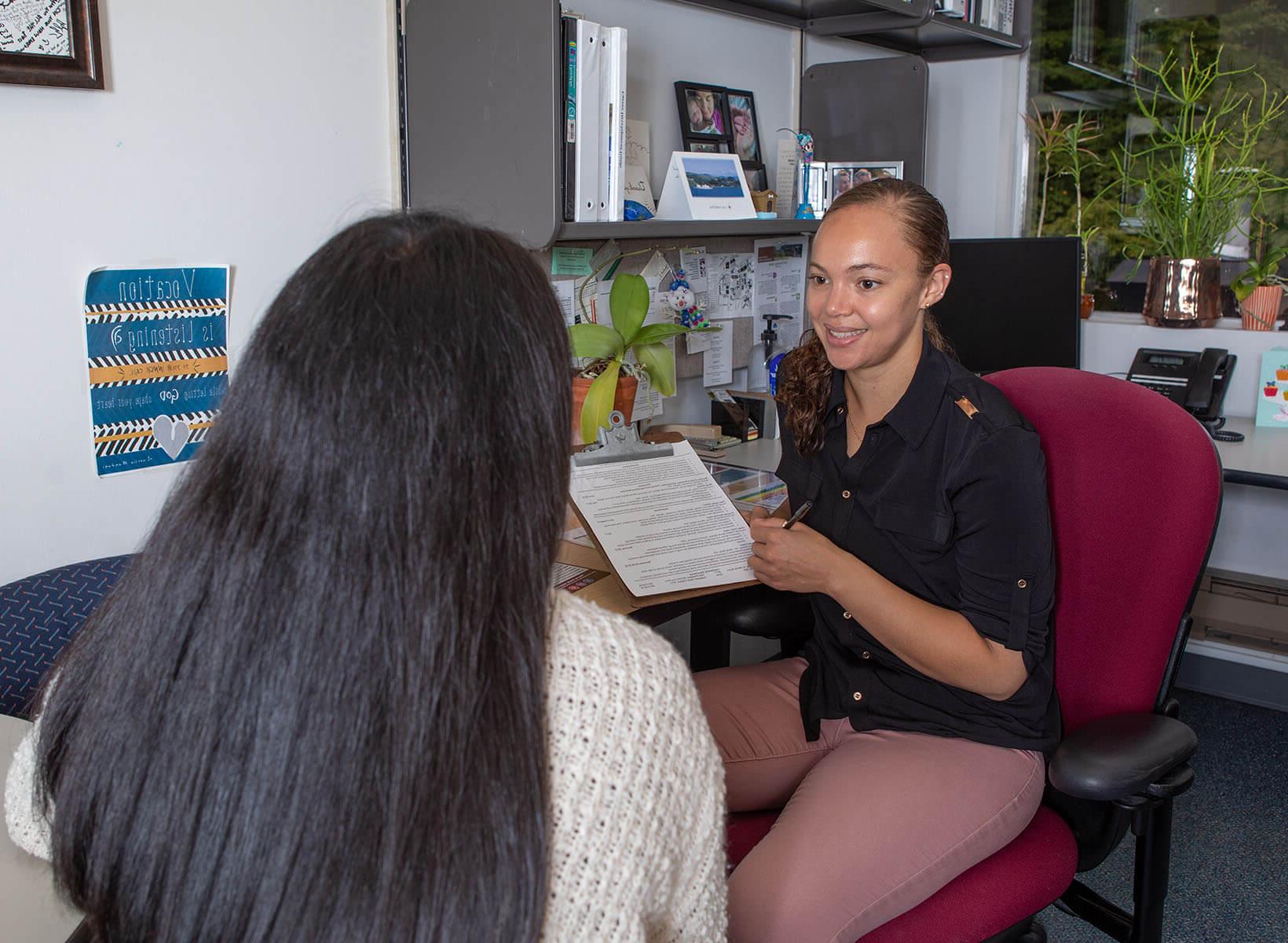 Karmen Baldwin provides a student with career resources | photo by Lynn Anselmi